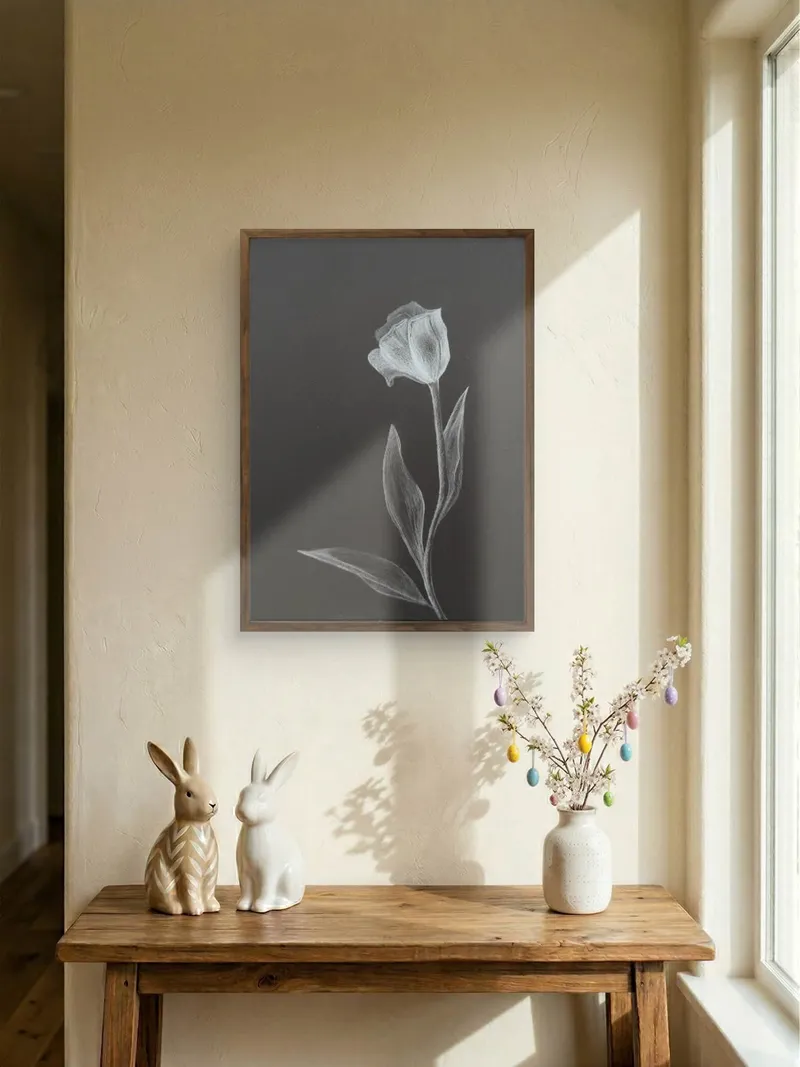 Framed white tulip drawing on black paper.