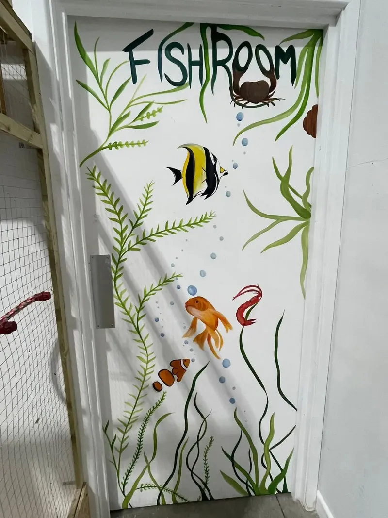 Hand-painted Fish Room door with aquatic plants and fish.
